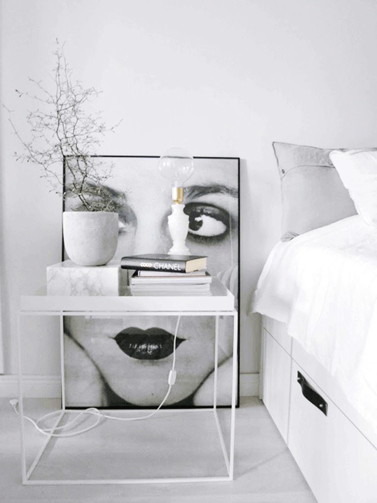 wBeautiful-bedroom-with-art.-bed-interior-decor-decoration-book-chanel-table-side-minimalist-woman-portrait-black